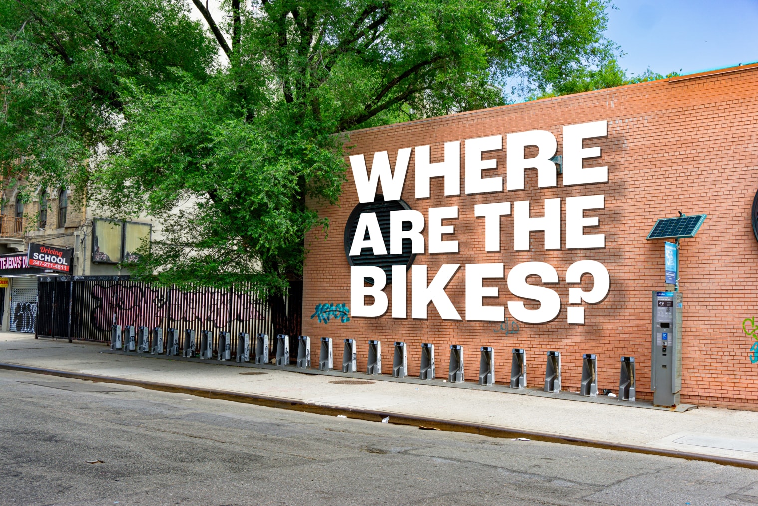 An empty Citi Bike station in the Bronx with overlay text reading 'Where are the bikes?'